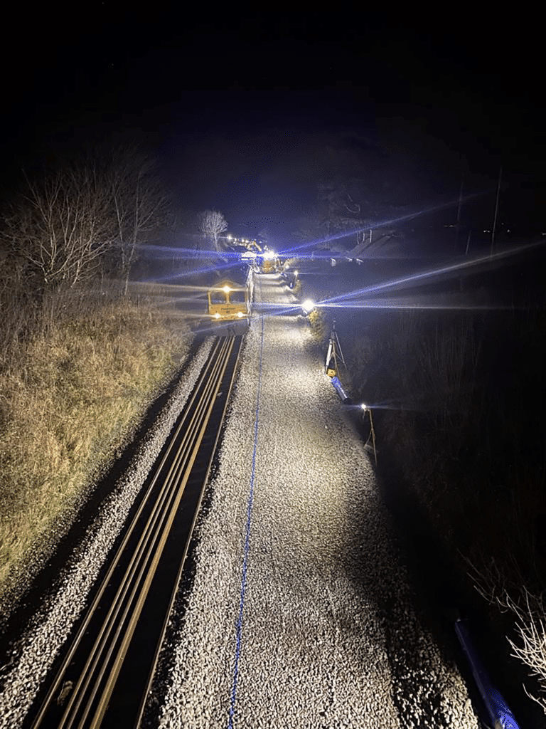 Protrack trackside at night with passing train