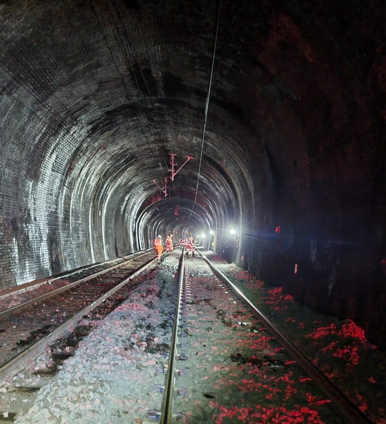 Protrack lighting up tunnel with workers